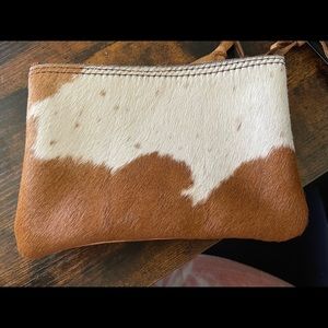 Brown and white hair on hide pouch